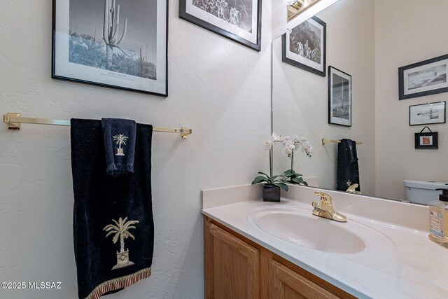3437 S Abrego Dr, Green Valley, AZ 85614 - half bath featuring toilet, vanity, and a textured wall