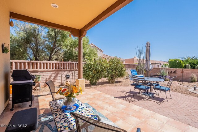 3437 S Abrego Dr, Green Valley, AZ 85614 - view of patio with outdoor dining area, a fenced backyard, and area for grilling