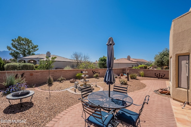 3437 S Abrego Dr, Green Valley, AZ 85614 - view of patio / terrace featuring outdoor dining area, a fenced backyard, and an outdoor fire pit