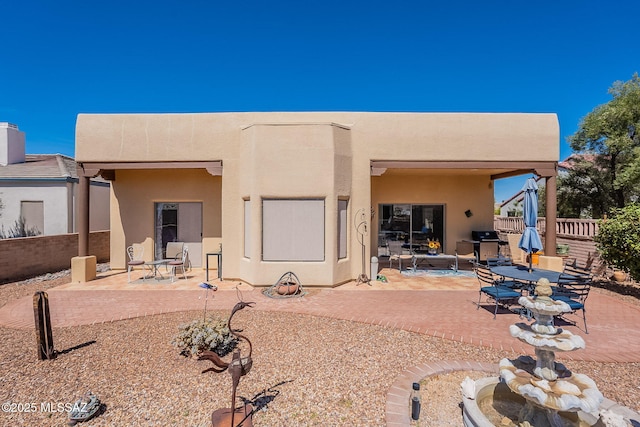 3437 S Abrego Dr, Green Valley, AZ 85614 - rear view of house with stucco siding, fence, and a patio area