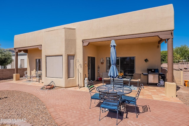 3437 S Abrego Dr, Green Valley, AZ 85614 - view of patio featuring outdoor dining space, fence, and a grill