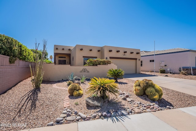 3437 S Abrego Dr, Green Valley, AZ 85614 - southwest-style home featuring stucco siding, concrete driveway, a fenced front yard, and an attached garage