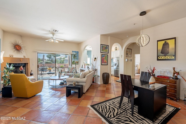 3437 S Abrego Dr, Green Valley, AZ 85614 - living area featuring a ceiling fan, light tile patterned flooring, arched walkways, and visible vents