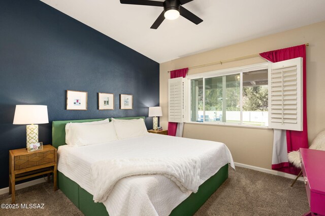 bedroom with a ceiling fan, vaulted ceiling, carpet, and baseboards