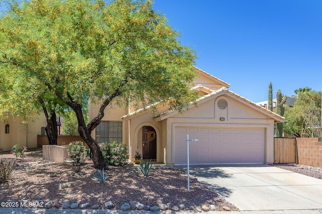 view of front facade featuring concrete driveway, a garage, fence, and stucco siding