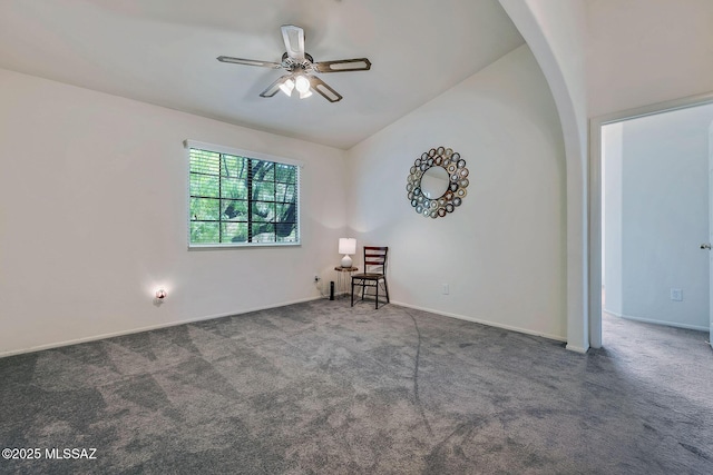 unfurnished room featuring carpet floors, lofted ceiling, baseboards, ceiling fan, and arched walkways
