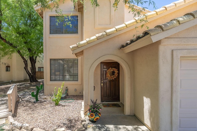 entrance to property featuring stucco siding