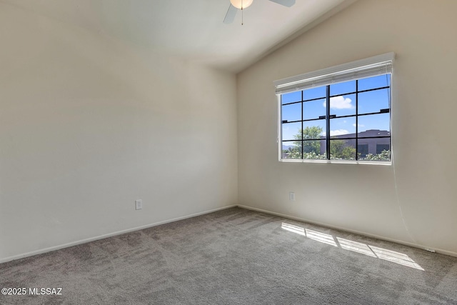 carpeted spare room featuring baseboards, ceiling fan, and lofted ceiling