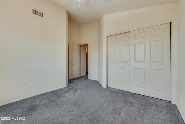 unfurnished bedroom featuring carpet flooring, a ceiling fan, baseboards, visible vents, and a closet