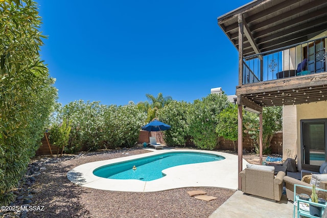 outdoor pool featuring a patio and a fenced backyard