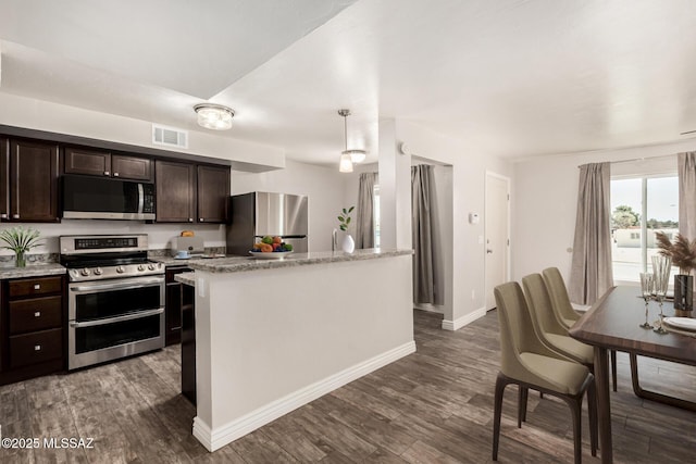 kitchen featuring appliances with stainless steel finishes, dark brown cabinetry, dark wood-style floors, and visible vents