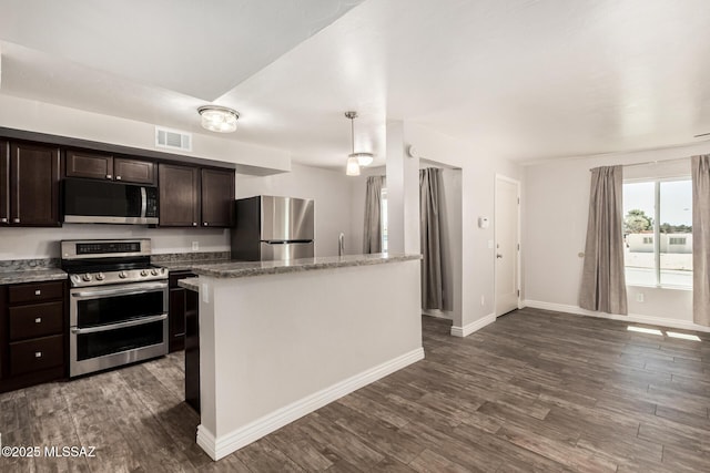 kitchen featuring dark wood-style flooring, visible vents, dark brown cabinets, baseboards, and stainless steel appliances