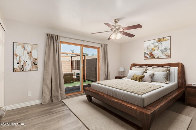 8851 E Elvenstone Way, Tucson, AZ 85730 - bedroom with access to outside, light wood-style flooring, baseboards, and ceiling fan