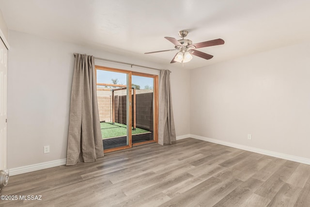 8851 E Elvenstone Way, Tucson, AZ 85730 - empty room with wood finished floors, baseboards, and a ceiling fan