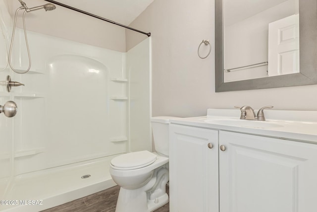 8851 E Elvenstone Way, Tucson, AZ 85730 - full bathroom featuring a shower, toilet, vanity, and wood finished floors