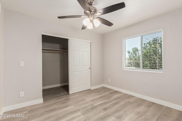8851 E Elvenstone Way, Tucson, AZ 85730 - unfurnished bedroom with light wood-type flooring, baseboards, a closet, and a ceiling fan