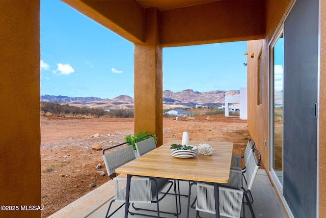 view of patio / terrace with a mountain view and outdoor dining space