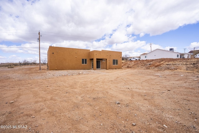 back of property with stucco siding