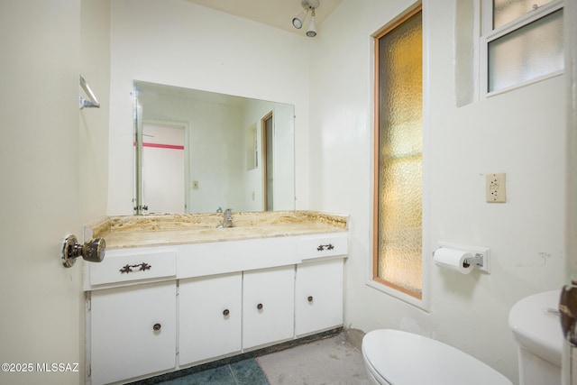 bathroom featuring toilet and vanity