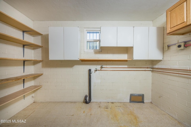 below grade area featuring concrete block wall
