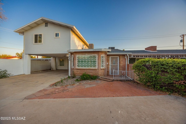 view of front of house with brick siding and concrete driveway