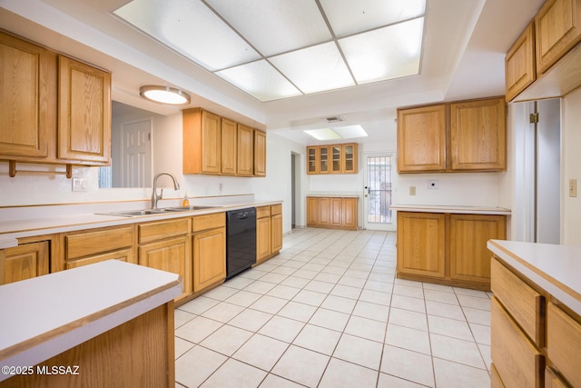 kitchen with light countertops, light tile patterned floors, a sink, visible vents, and black dishwasher