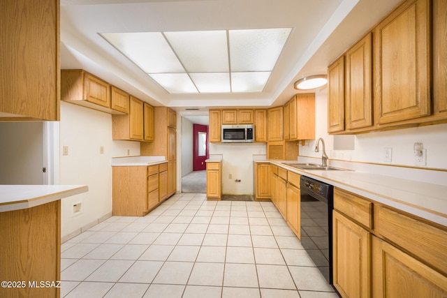 kitchen with light countertops, stainless steel microwave, light tile patterned floors, a sink, and dishwasher