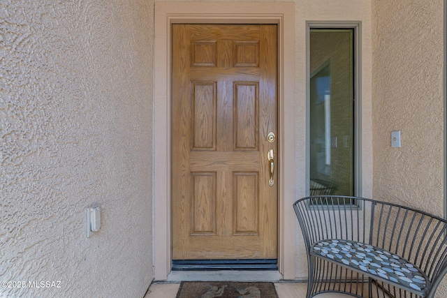 property entrance featuring stucco siding