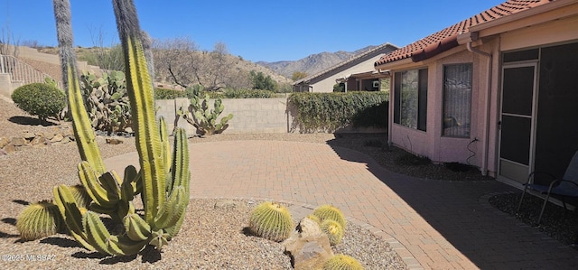 view of patio / terrace featuring a mountain view and a fenced backyard