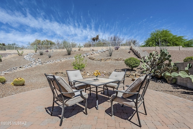 view of patio featuring a fenced backyard and outdoor dining area