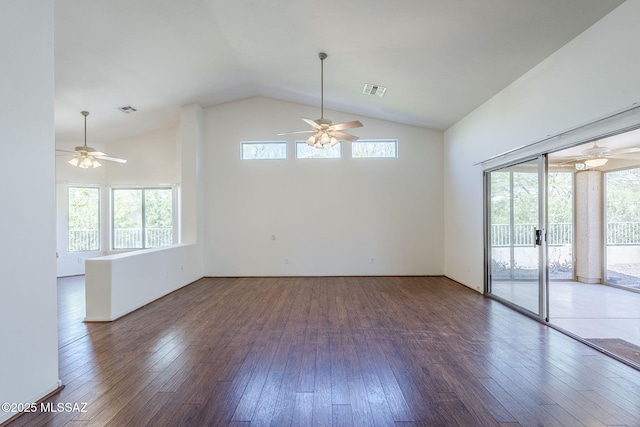 empty room featuring lofted ceiling, a ceiling fan, and visible vents