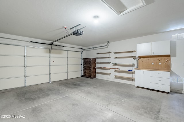 garage featuring visible vents and a garage door opener