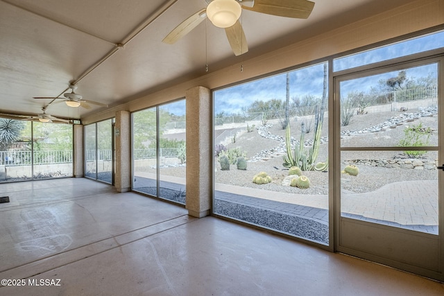 unfurnished sunroom featuring a healthy amount of sunlight and finished concrete floors