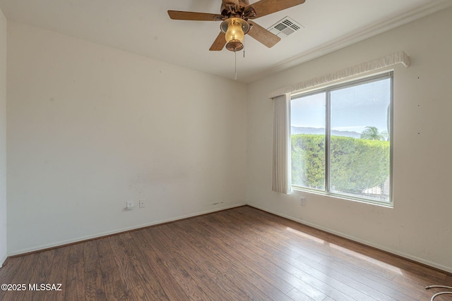 unfurnished room featuring visible vents, baseboards, a ceiling fan, and wood finished floors