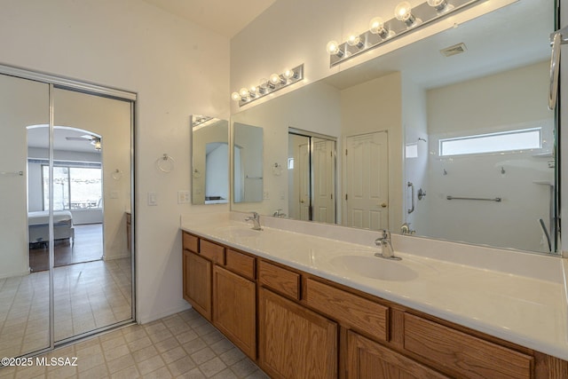 full bath with double vanity, visible vents, ensuite bathroom, and a sink