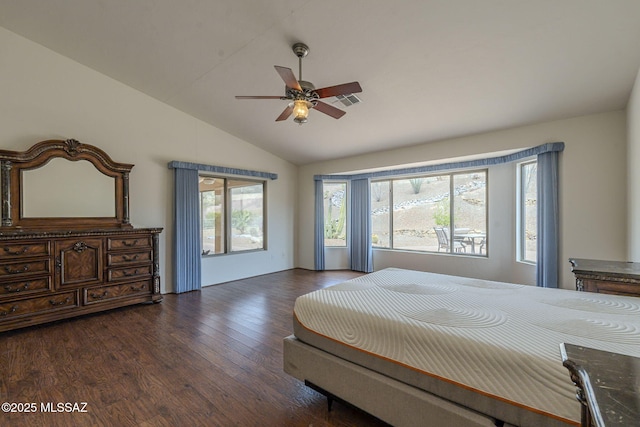 bedroom with ceiling fan, lofted ceiling, wood finished floors, and visible vents