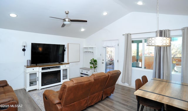 living room featuring lofted ceiling, wood finished floors, recessed lighting, and a ceiling fan