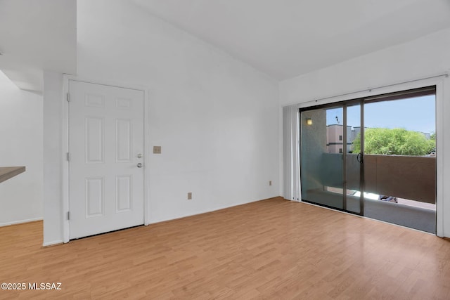 2172 N Pantano Rd Unit 217, Tucson, AZ 85715 - spare room featuring wood finished floors and vaulted ceiling