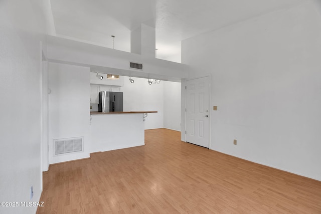 2172 N Pantano Rd Unit 217, Tucson, AZ 85715 - unfurnished living room featuring light wood-style flooring