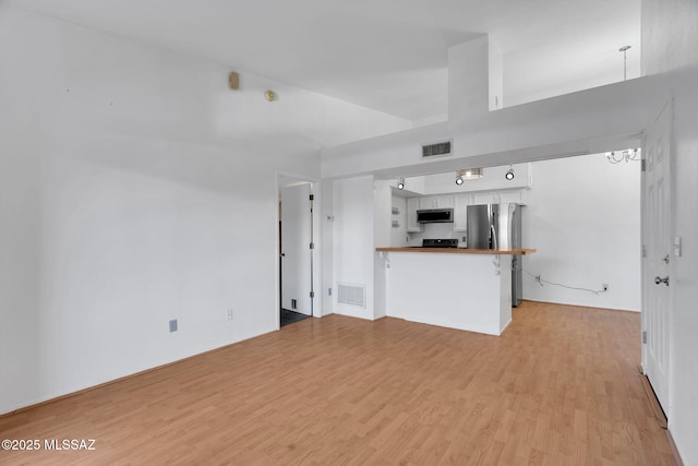 2172 N Pantano Rd Unit 217, Tucson, AZ 85715 - unfurnished living room featuring light wood finished floors