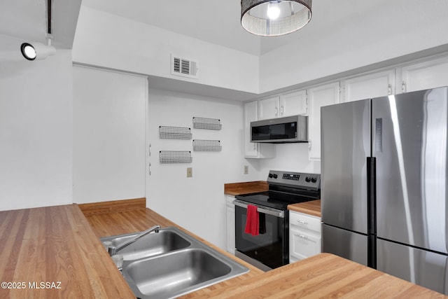 2172 N Pantano Rd Unit 217, Tucson, AZ 85715 - kitchen with stainless steel appliances, butcher block countertops, a sink, and white cabinets
