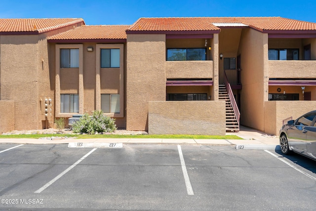 2172 N Pantano Rd Unit 217, Tucson, AZ 85715 - view of building exterior with stairway and uncovered parking