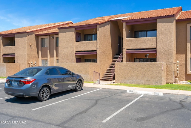 2172 N Pantano Rd Unit 217, Tucson, AZ 85715 - view of property featuring uncovered parking and stairway
