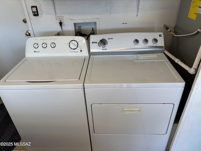 clothes washing area featuring laundry area and washing machine and dryer
