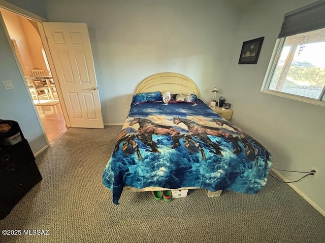 bedroom featuring carpet floors and baseboards