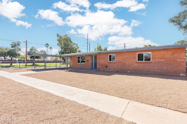 ranch-style house featuring brick siding and concrete driveway