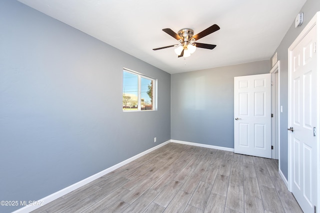 unfurnished bedroom with baseboards, ceiling fan, and light wood finished floors