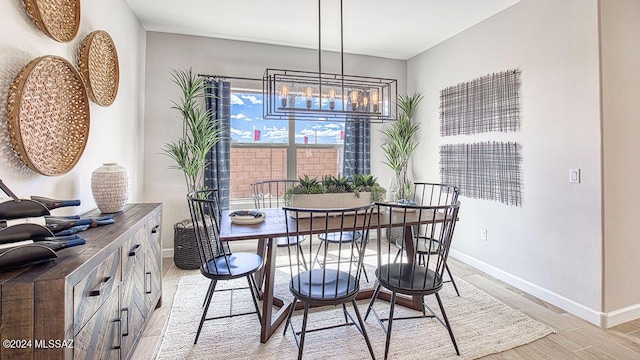 dining room with baseboards and light wood-type flooring
