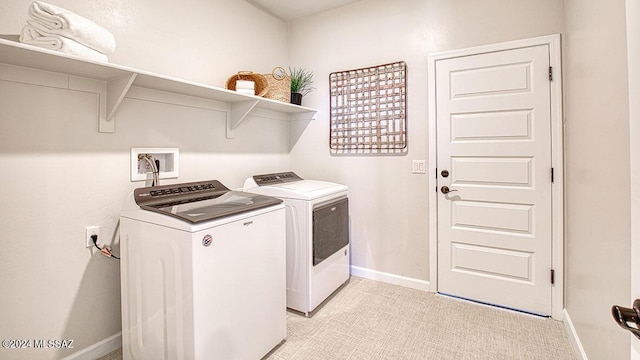 laundry room featuring washer and clothes dryer, laundry area, and baseboards