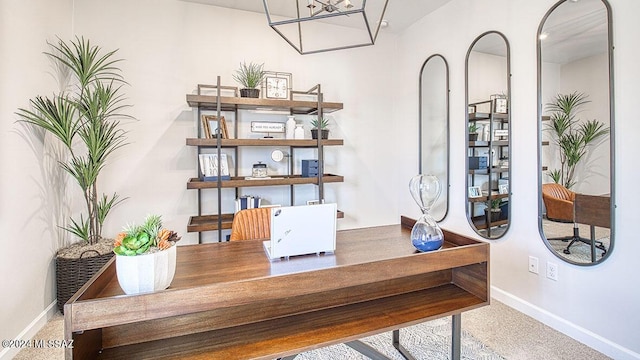 office space with baseboards and a notable chandelier